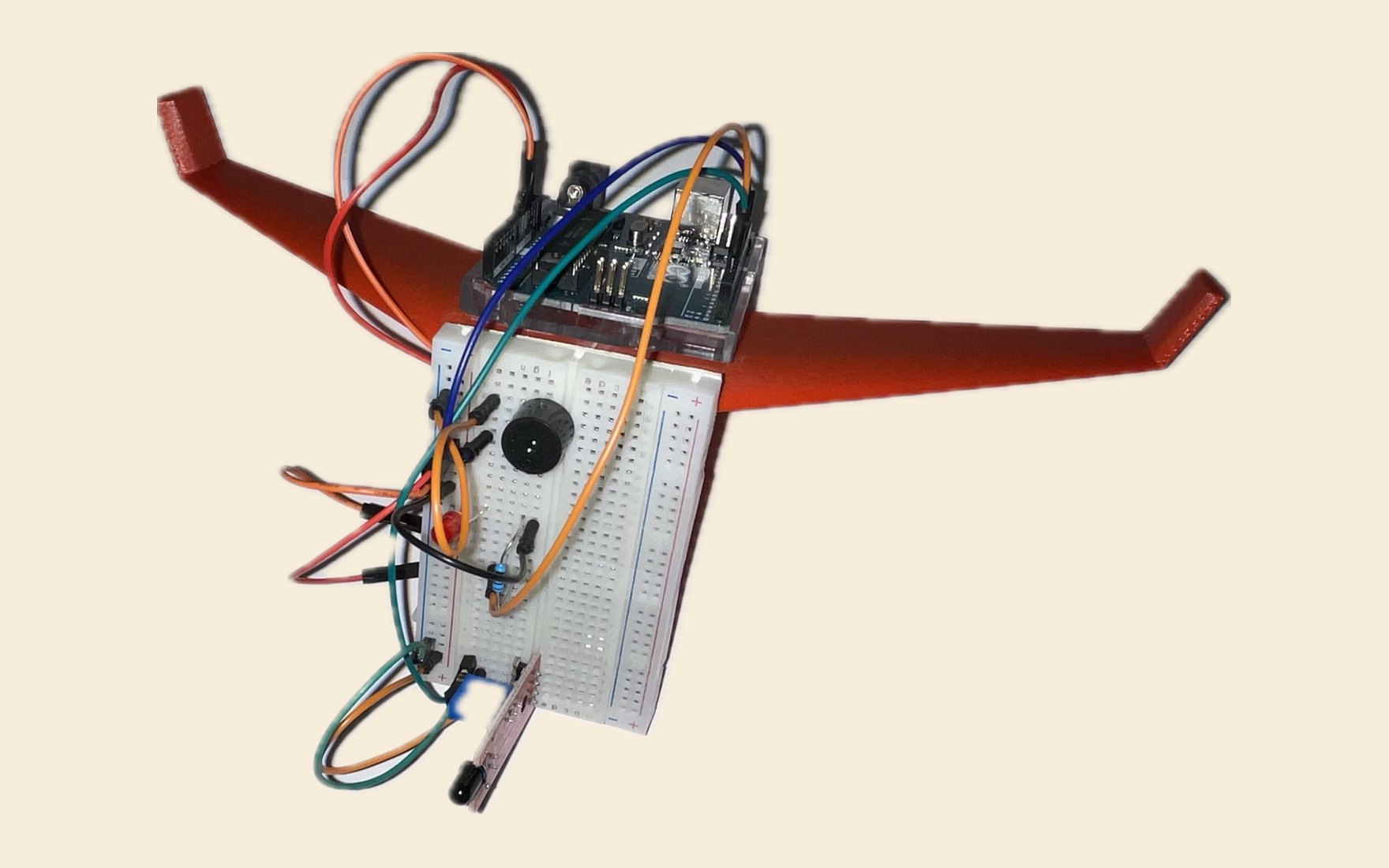 The IGNIS prototype: a terracotta 3D-printed flying-wing airframe with a breadboard and an Arduino Uno mounted on top, wired to a buzzer, an LED, and flame and temperature sensors