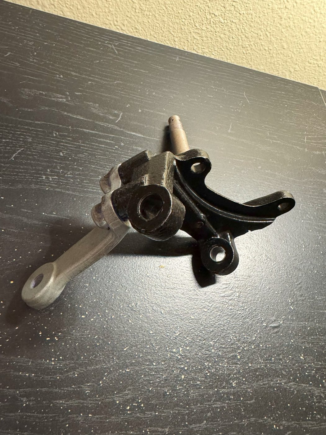 The real machined aluminum steering upright resting on a workbench